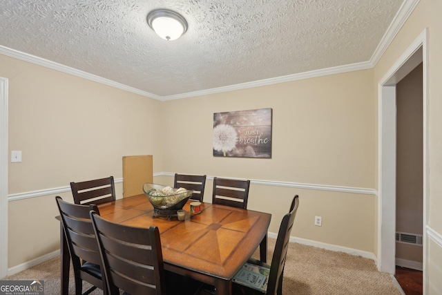 carpeted dining space with crown molding, visible vents, and a textured ceiling