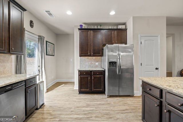 kitchen featuring visible vents, light wood-style flooring, stainless steel appliances, dark brown cabinetry, and decorative backsplash