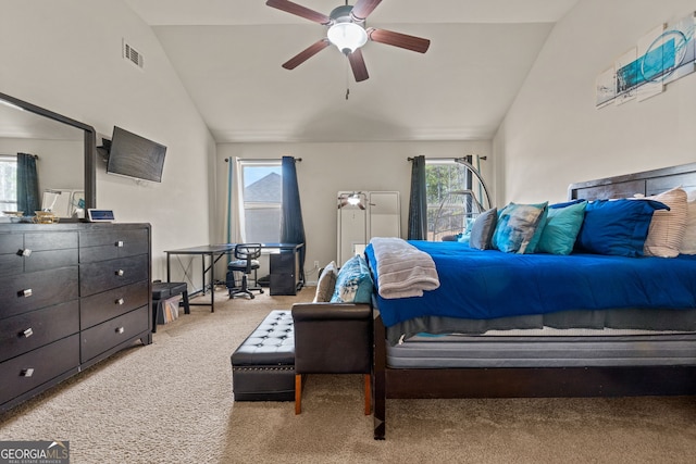 carpeted bedroom featuring visible vents, lofted ceiling, and ceiling fan