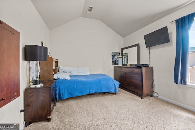 bedroom featuring visible vents, lofted ceiling, light colored carpet, and baseboards