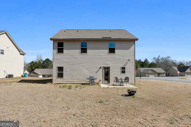 rear view of house featuring cooling unit and a patio