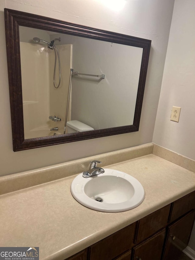 full bathroom featuring shower / bath combination, toilet, and vanity