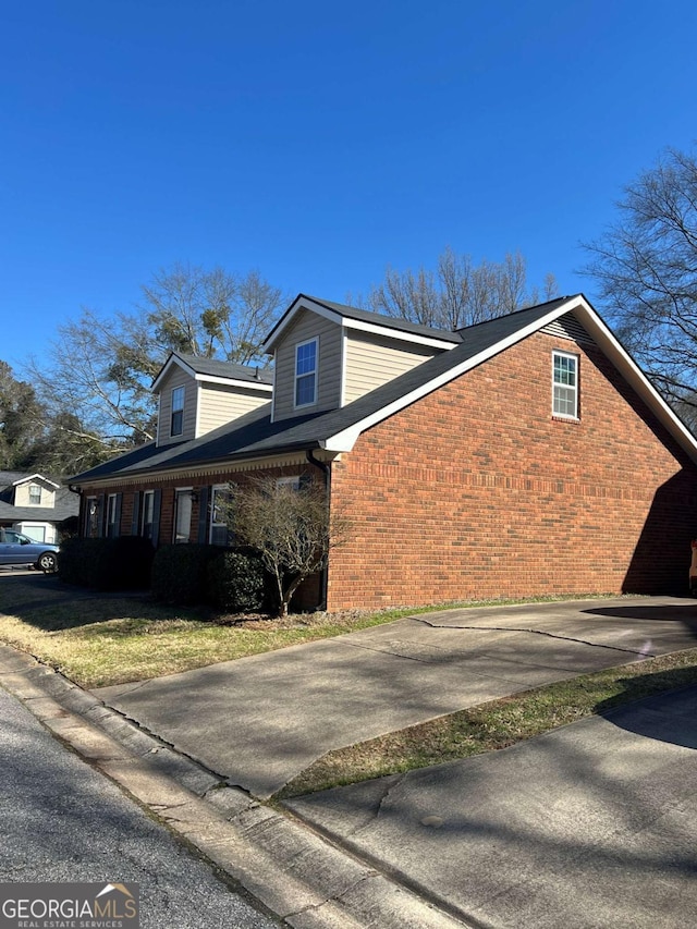 view of side of property with brick siding