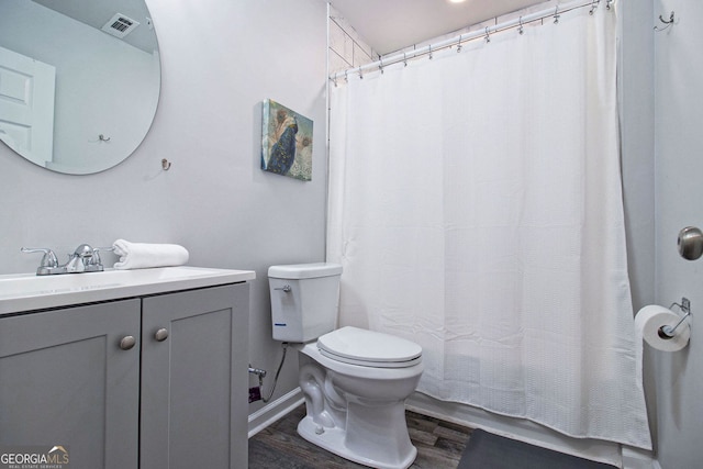 full bath featuring visible vents, baseboards, toilet, wood finished floors, and vanity