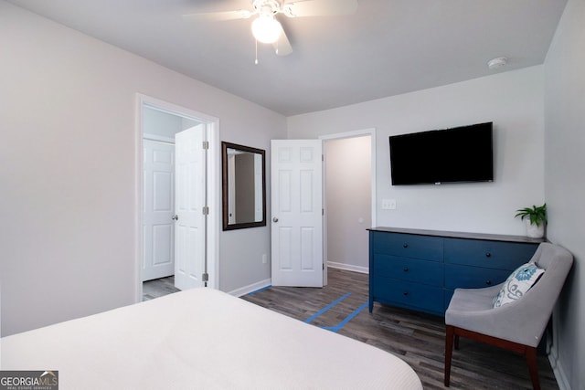 bedroom with baseboards, dark wood finished floors, and a ceiling fan