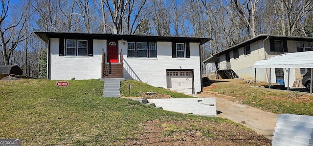 view of front facade with brick siding, an attached garage, and a front lawn