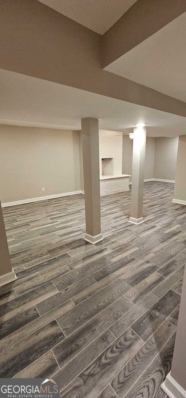 finished basement with baseboards and dark wood-style flooring