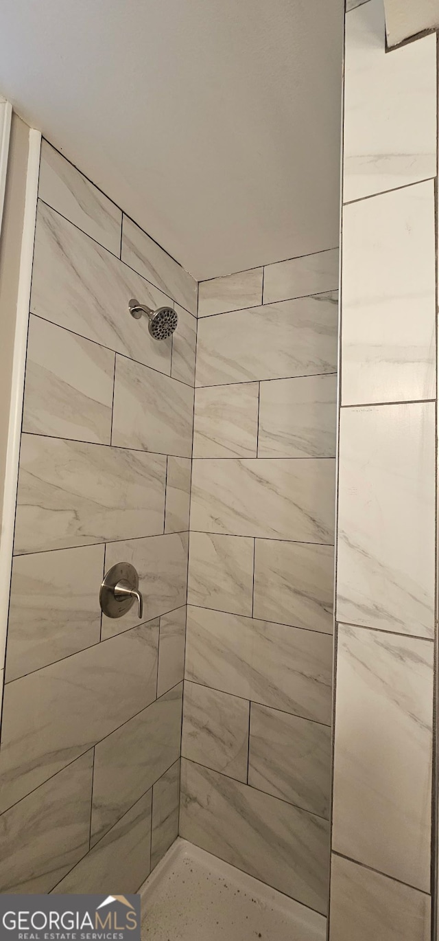 bathroom with a tile shower