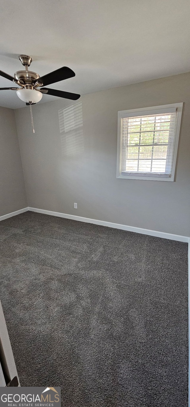 empty room with baseboards and carpet floors