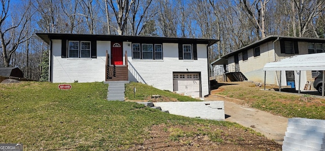 view of front of house with a front yard, brick siding, and an attached garage