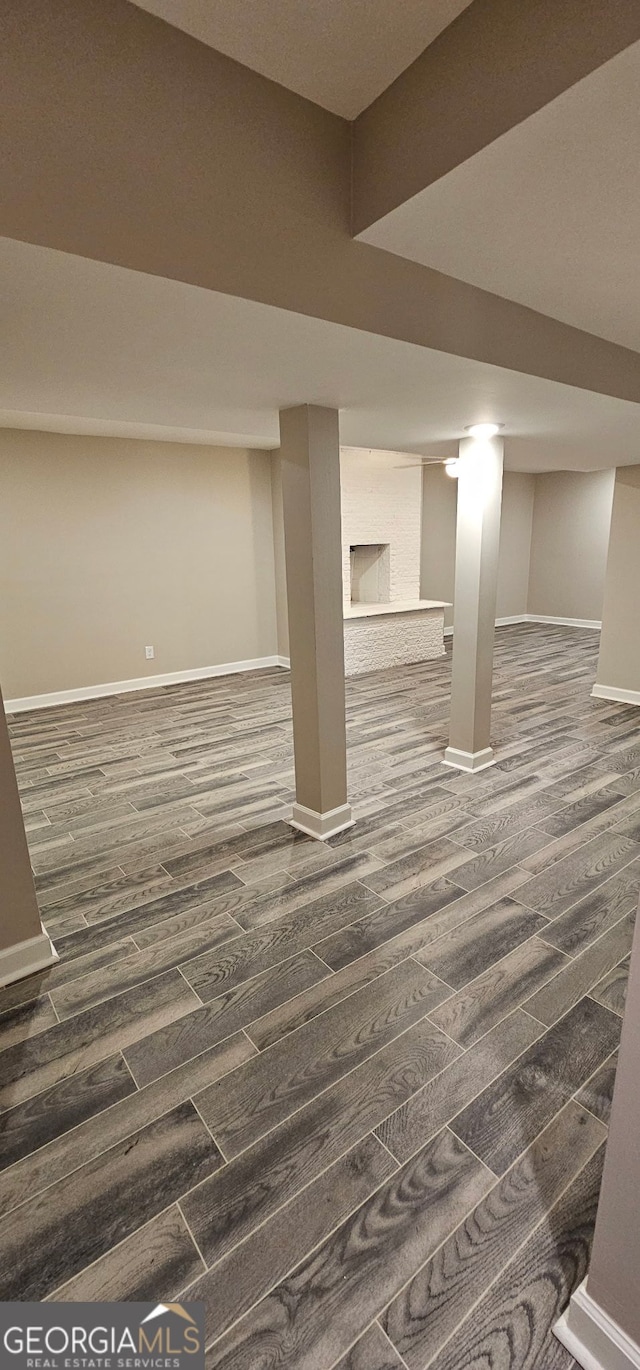 finished basement with dark wood-type flooring and baseboards