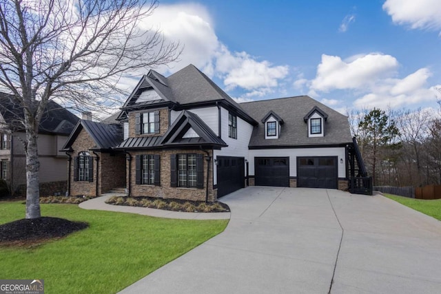 view of front of home featuring a front lawn, a standing seam roof, concrete driveway, an attached garage, and metal roof