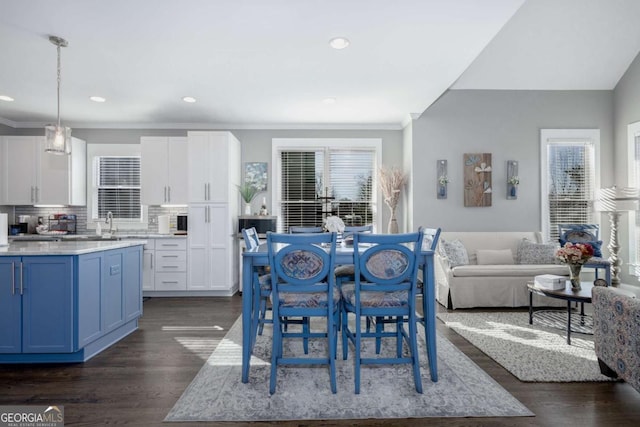 dining space featuring recessed lighting, ornamental molding, and dark wood-style flooring