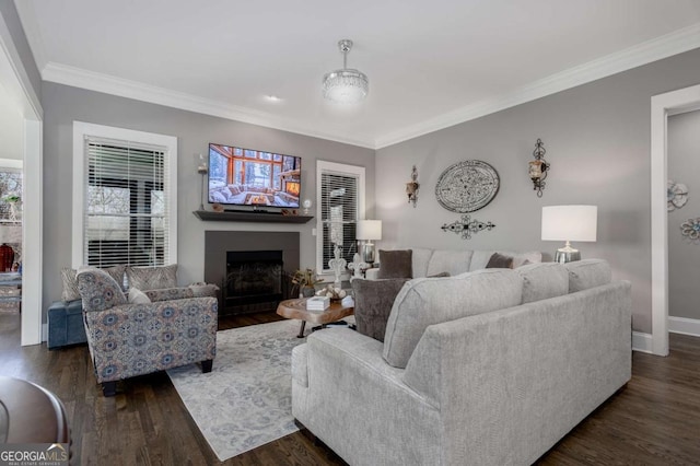 living room with dark wood finished floors, a fireplace, crown molding, and baseboards