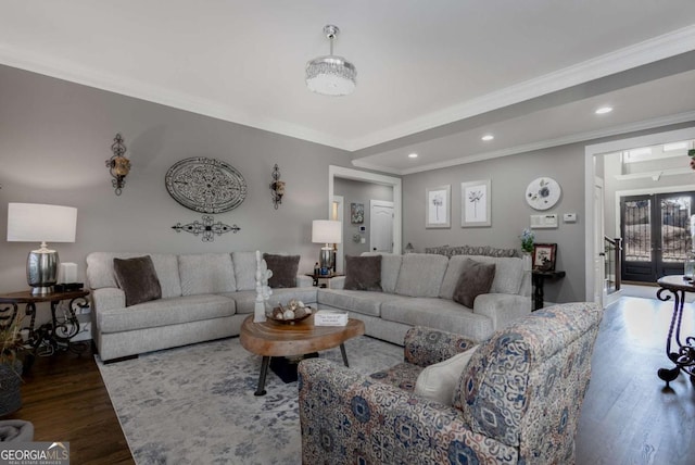 living area with crown molding, recessed lighting, wood finished floors, and french doors