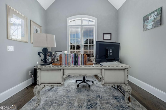 office featuring vaulted ceiling, wood finished floors, and baseboards