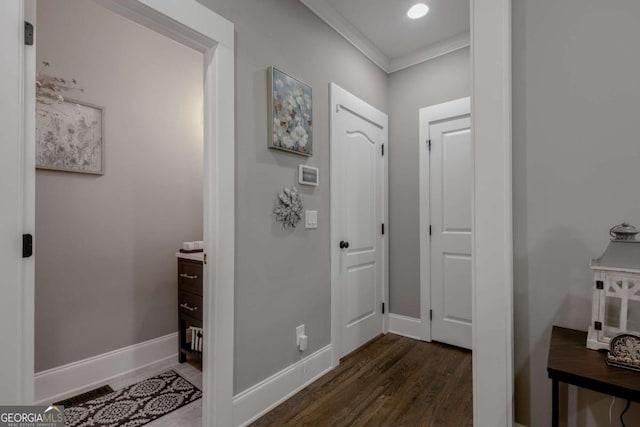 interior space featuring recessed lighting, baseboards, ornamental molding, and dark wood-style flooring