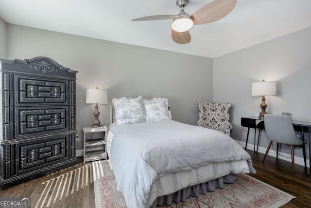 bedroom with ceiling fan, baseboards, and wood finished floors