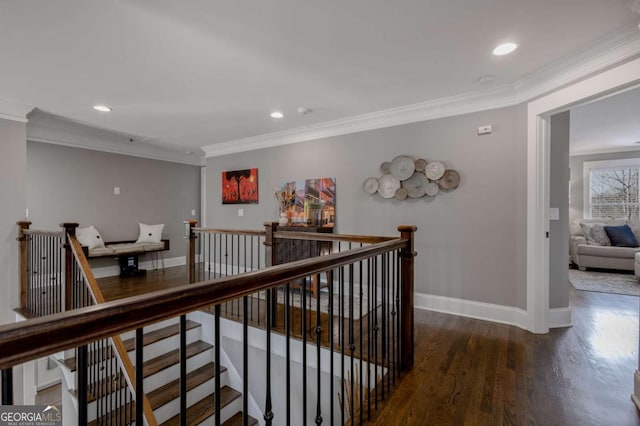 hall featuring an upstairs landing, wood finished floors, recessed lighting, crown molding, and baseboards