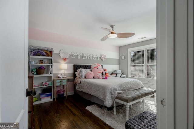 bedroom with visible vents, wood finished floors, and a ceiling fan