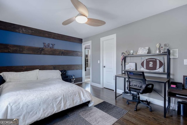 bedroom featuring a ceiling fan, baseboards, and wood finished floors