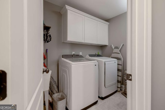 laundry area with cabinet space and washer and clothes dryer