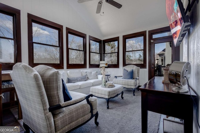 carpeted living area featuring lofted ceiling and ceiling fan