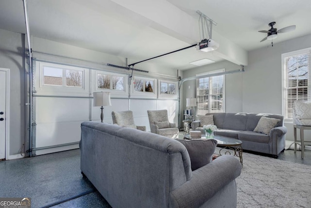 living area featuring beam ceiling, a baseboard heating unit, speckled floor, and a garage