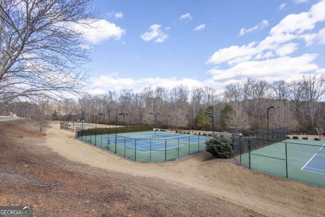 view of pool with a tennis court and fence