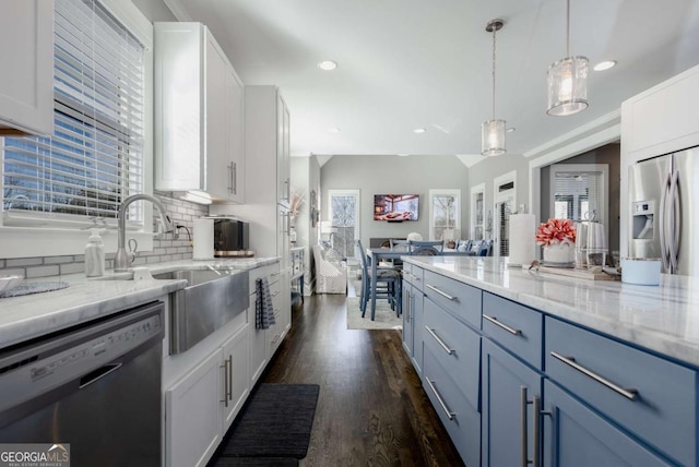 kitchen with dishwashing machine, light stone counters, white cabinets, stainless steel refrigerator with ice dispenser, and backsplash