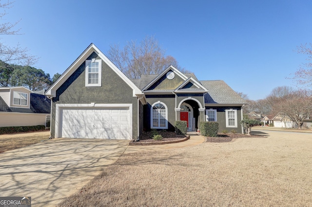 view of front of home with concrete driveway and stucco siding