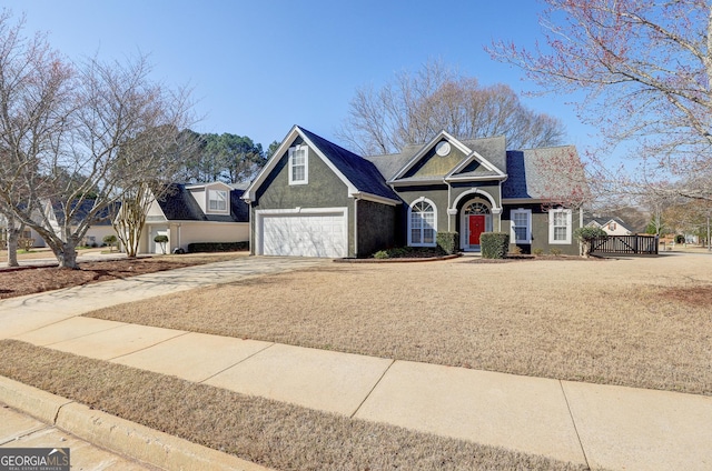 view of front of property featuring concrete driveway, a garage, and stucco siding