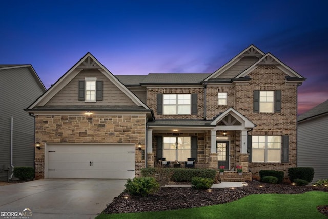 craftsman inspired home with brick siding, concrete driveway, and a garage