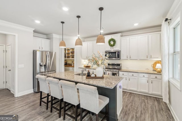 6902 Lancaster Xing, Flowery Branch, GA 30542 - kitchen featuring white cabinetry, appliances with stainless steel finishes, a sink, and wood finished floors