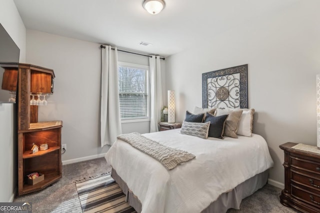 carpeted bedroom featuring visible vents and baseboards