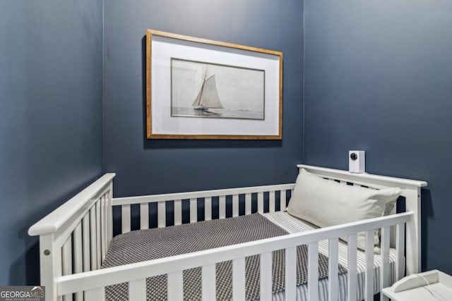 bedroom featuring a nursery area