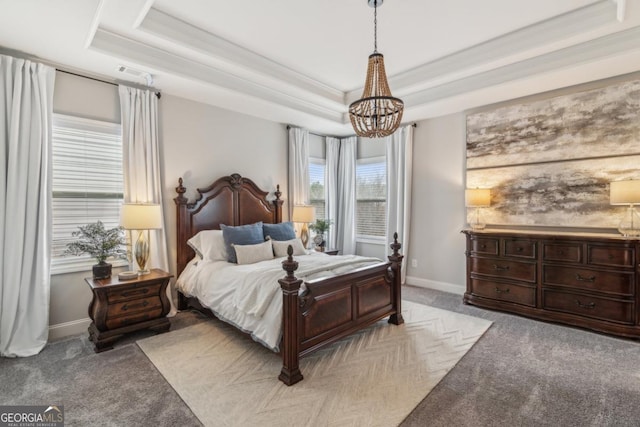 bedroom featuring light carpet, a notable chandelier, a raised ceiling, and baseboards