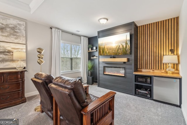 interior space featuring a large fireplace, baseboards, and carpet floors