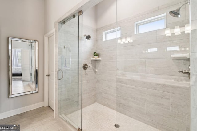 6902 Lancaster Xing, Flowery Branch, GA 30542 - bathroom featuring baseboards, a stall shower, and connected bathroom