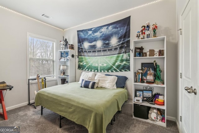 carpeted bedroom featuring visible vents and baseboards