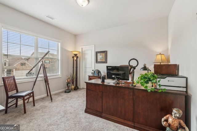 office space with light carpet, visible vents, and baseboards