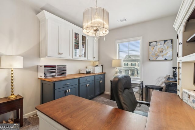 home office with baseboards, visible vents, dark colored carpet, and a chandelier