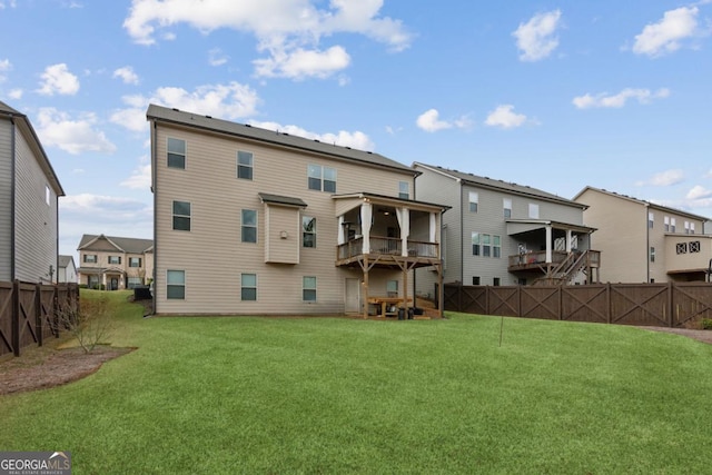 back of property featuring a yard and fence