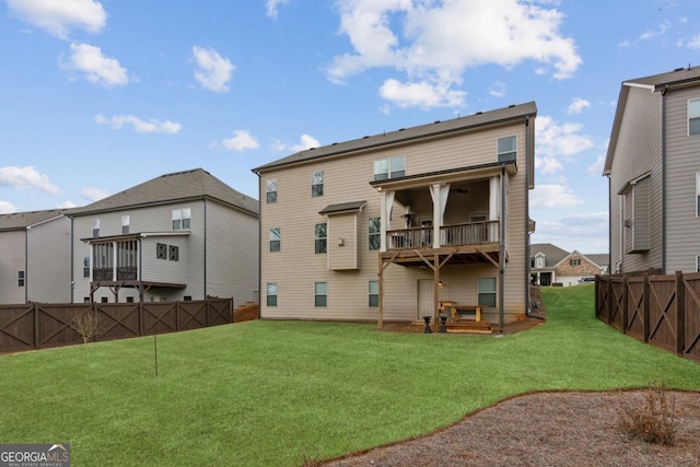 6902 Lancaster Xing, Flowery Branch, GA 30542 - rear view of house featuring fence, a lawn, and a balcony