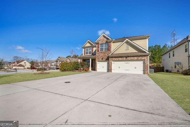 view of front facade featuring a garage, driveway, brick siding, and a front yard