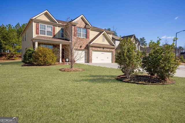 view of front of property featuring driveway, brick siding, an attached garage, and a front yard