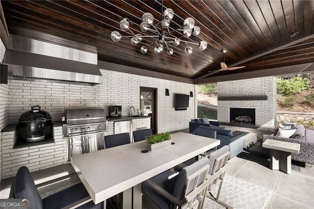 view of patio featuring area for grilling, outdoor dining space, a sink, grilling area, and ceiling fan