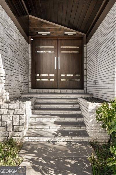 view of exterior entry with covered porch