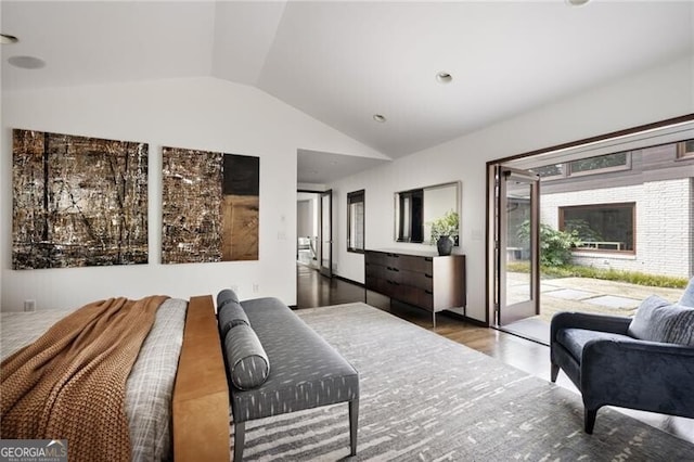 bedroom featuring access to exterior, wood finished floors, and vaulted ceiling