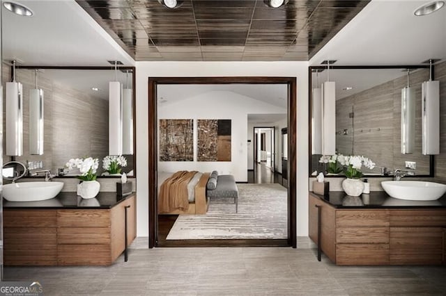 full bathroom with a sink and two vanities